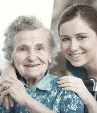 A therapist helping a senior with an at-home exercise